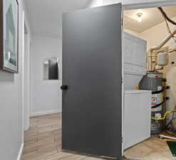 Utility room featuring stacked washer / dryer
