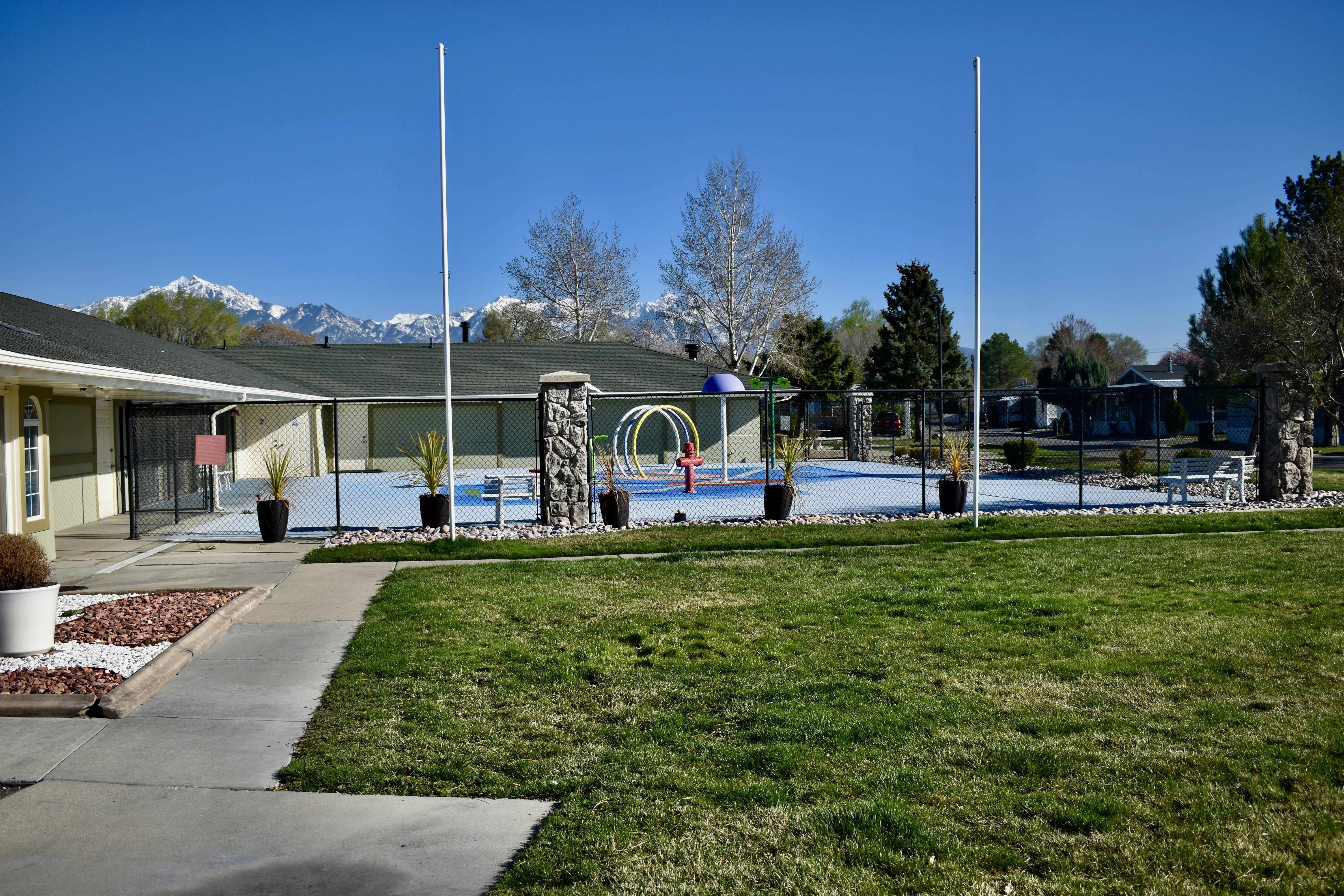 View of property's community with a splash pad and a mountain view
