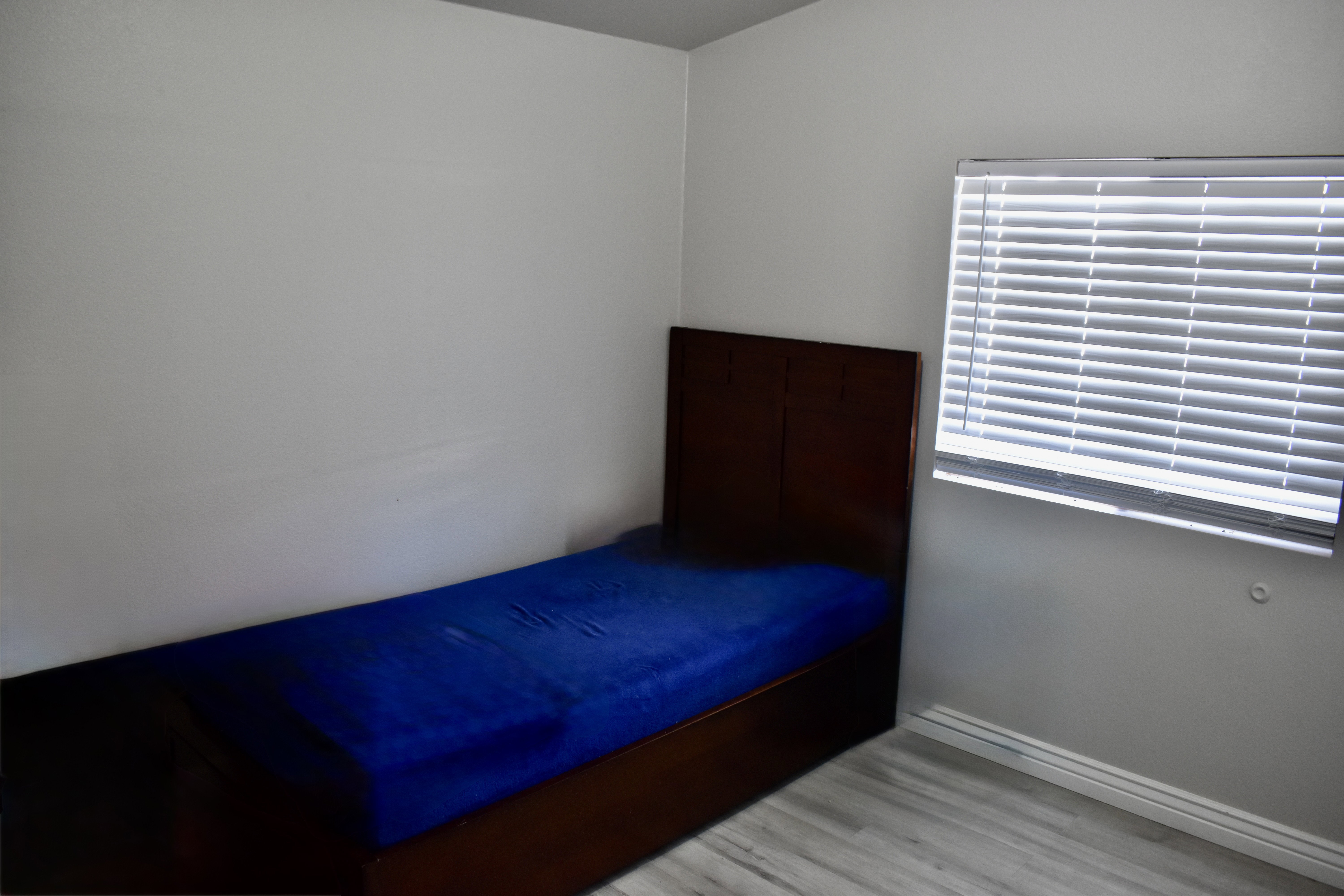 Unfurnished bedroom with light wood-style flooring and baseboards