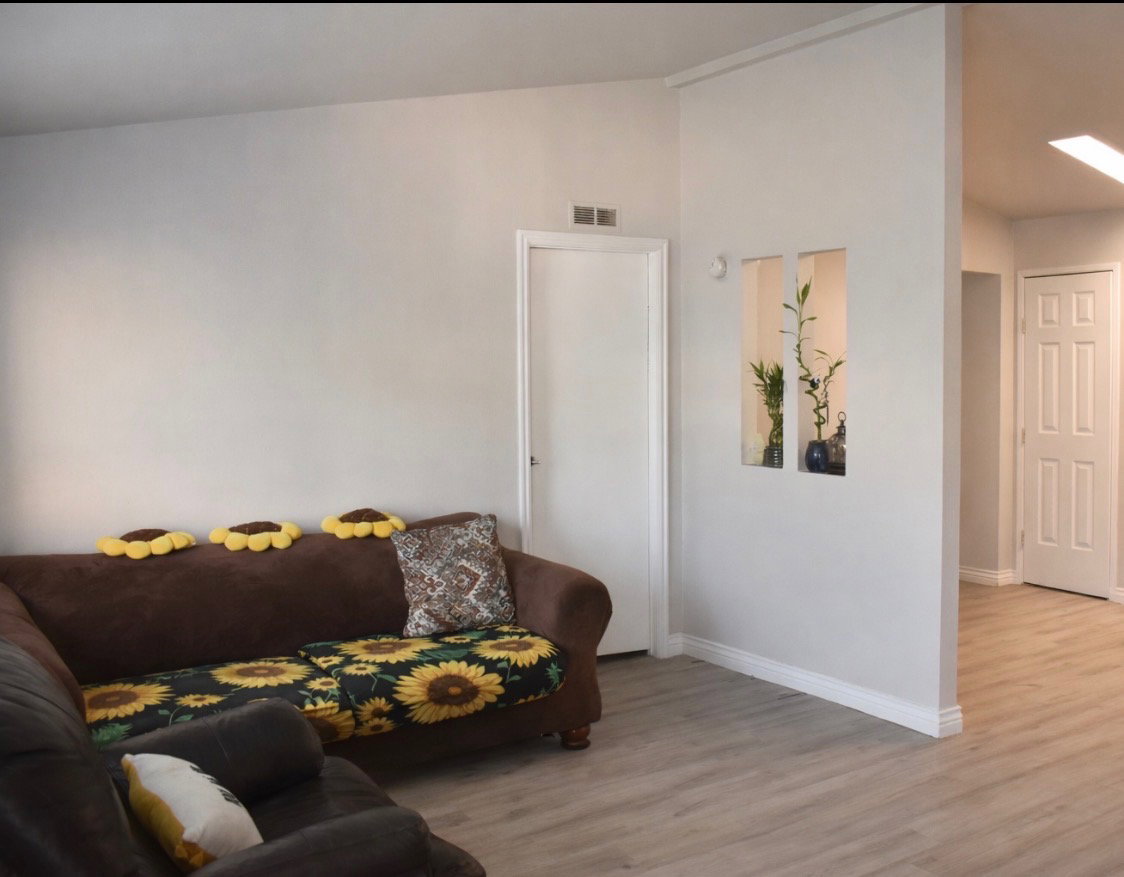 Living room with lofted ceiling and light wood finished floors