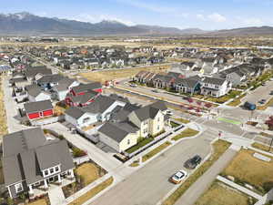 Aerial overview of property's location featuring a mountain backdrop and nearby suburban area