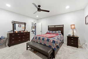 Bedroom with light colored carpet, ceiling fan, and recessed lighting