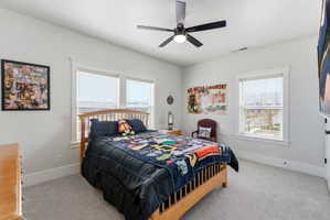 Bedroom featuring light carpet and ceiling fan