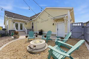 Rear view of house with a patio area, a gate, a fire pit, and entry steps