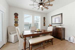 Dining room featuring light wood-type flooring and a ceiling fan