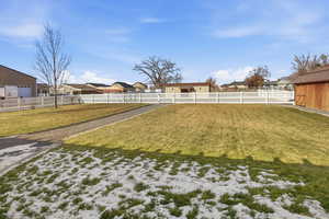 Fenced yard with a residential view