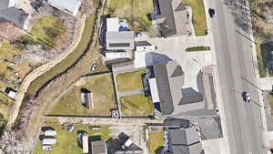 Aerial view of property and surrounding area featuring nearby suburban area