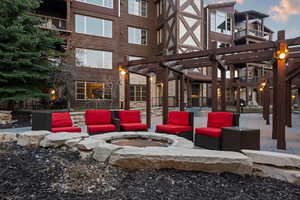 View of patio / terrace featuring an outdoor fire pit and a pergola
