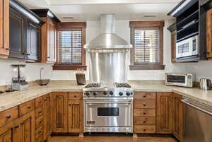 Kitchen featuring stainless steel appliances and wood finish cabinetry