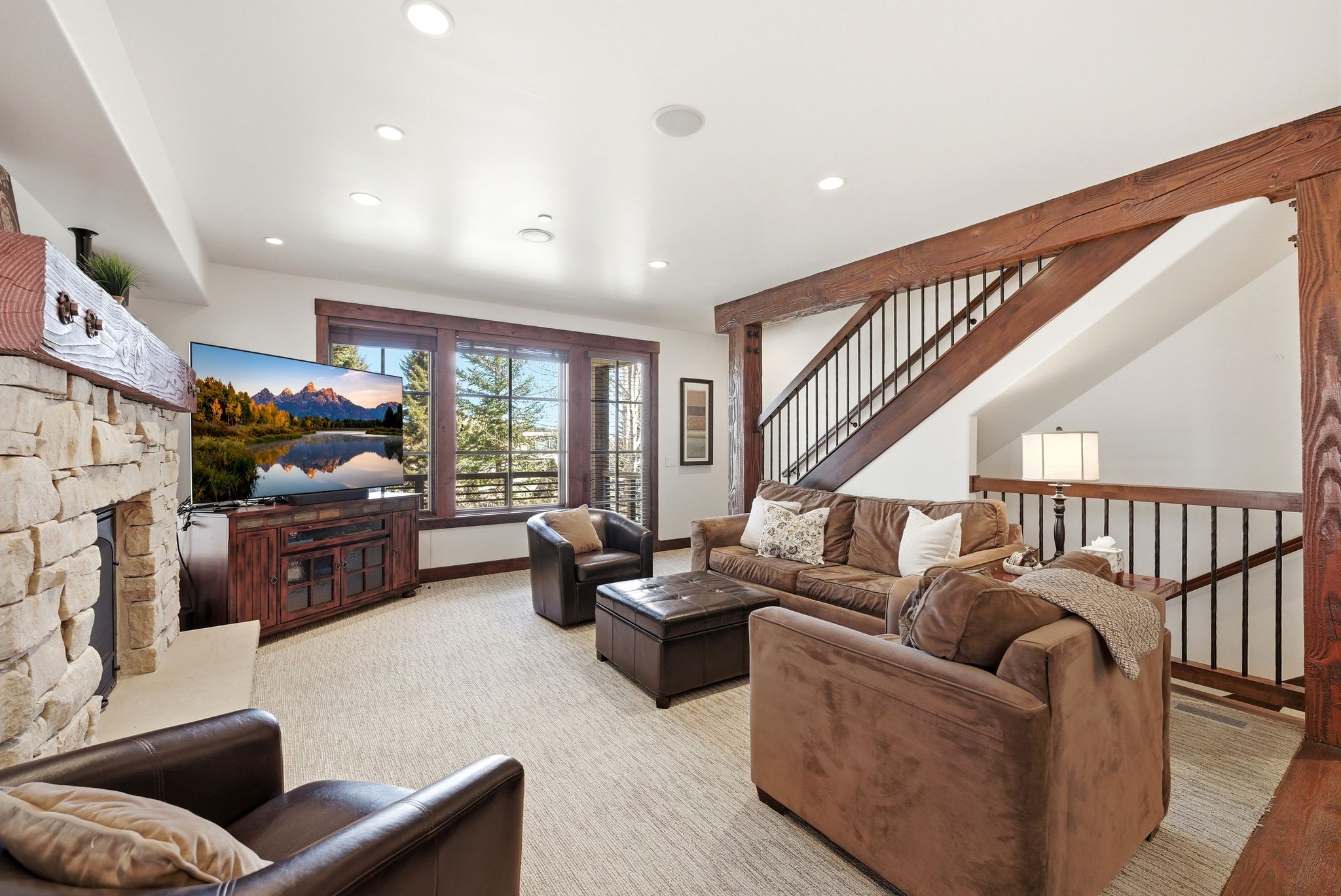 Living room featuring a fireplace, recessed lighting, and light colored carpet