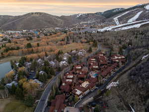Aerial overview of property's location with nearby suburban area and a mountain backdrop