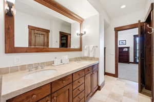 Bathroom with double vanity, a stall shower, and recessed lighting