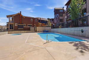 Community pool featuring a patio