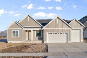 View of front of home featuring a garage, a mountain view, covered porch, and concrete driveway