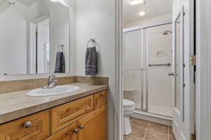Primary ensuite bath featuring an oversized shower with built-in bench and cultured marble surround.