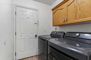 Main level laundry space with built-in cabinetry for added storage and convenience.