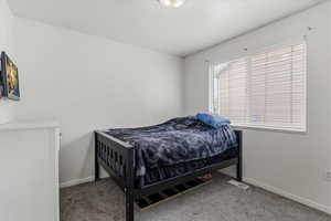 One of five bedrooms offering flexible space within the home’s functional layout.