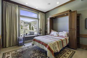 Bedroom featuring light wood-style floors, ornamental molding, and recessed lighting