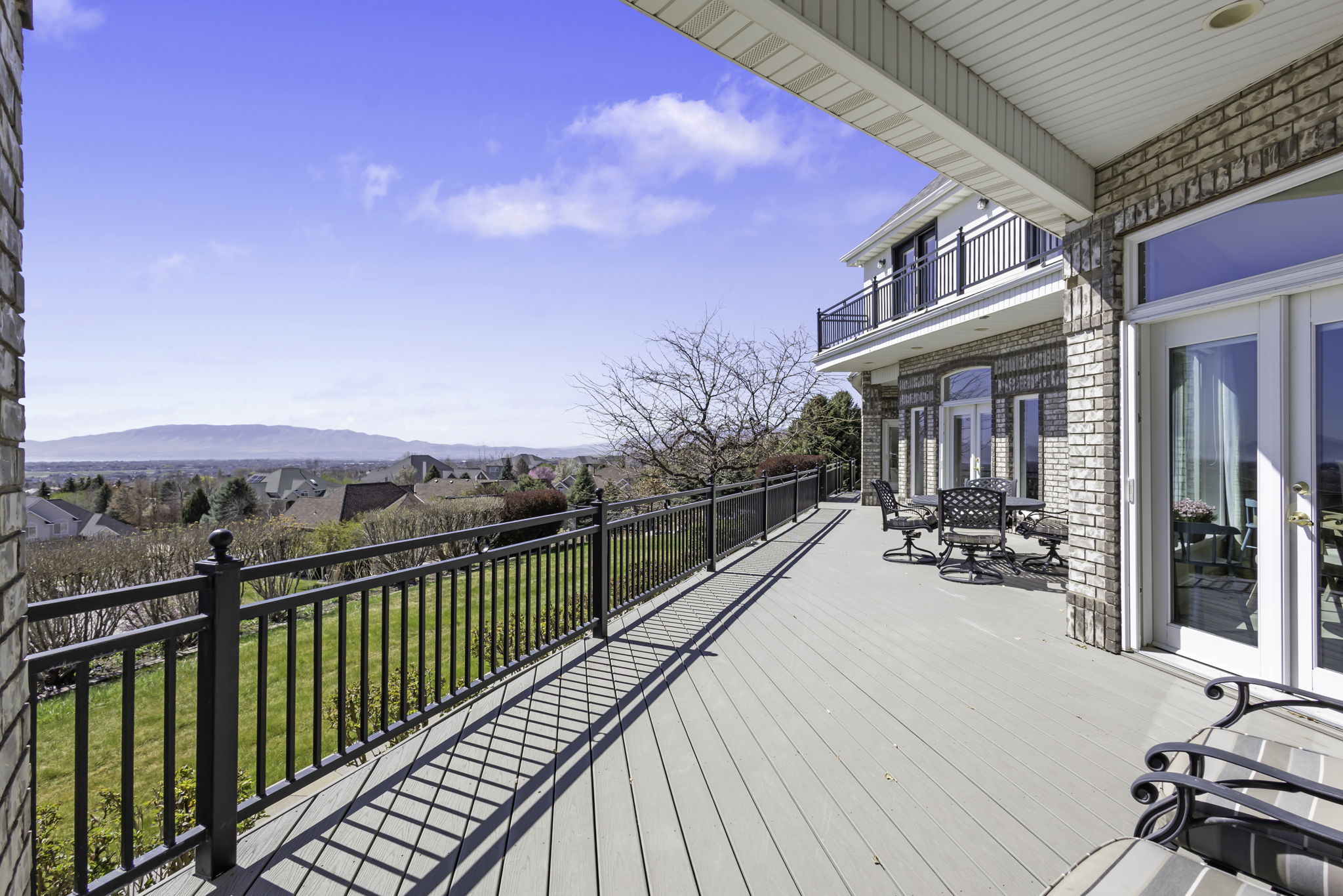 Wooden deck featuring a residential view and a yard