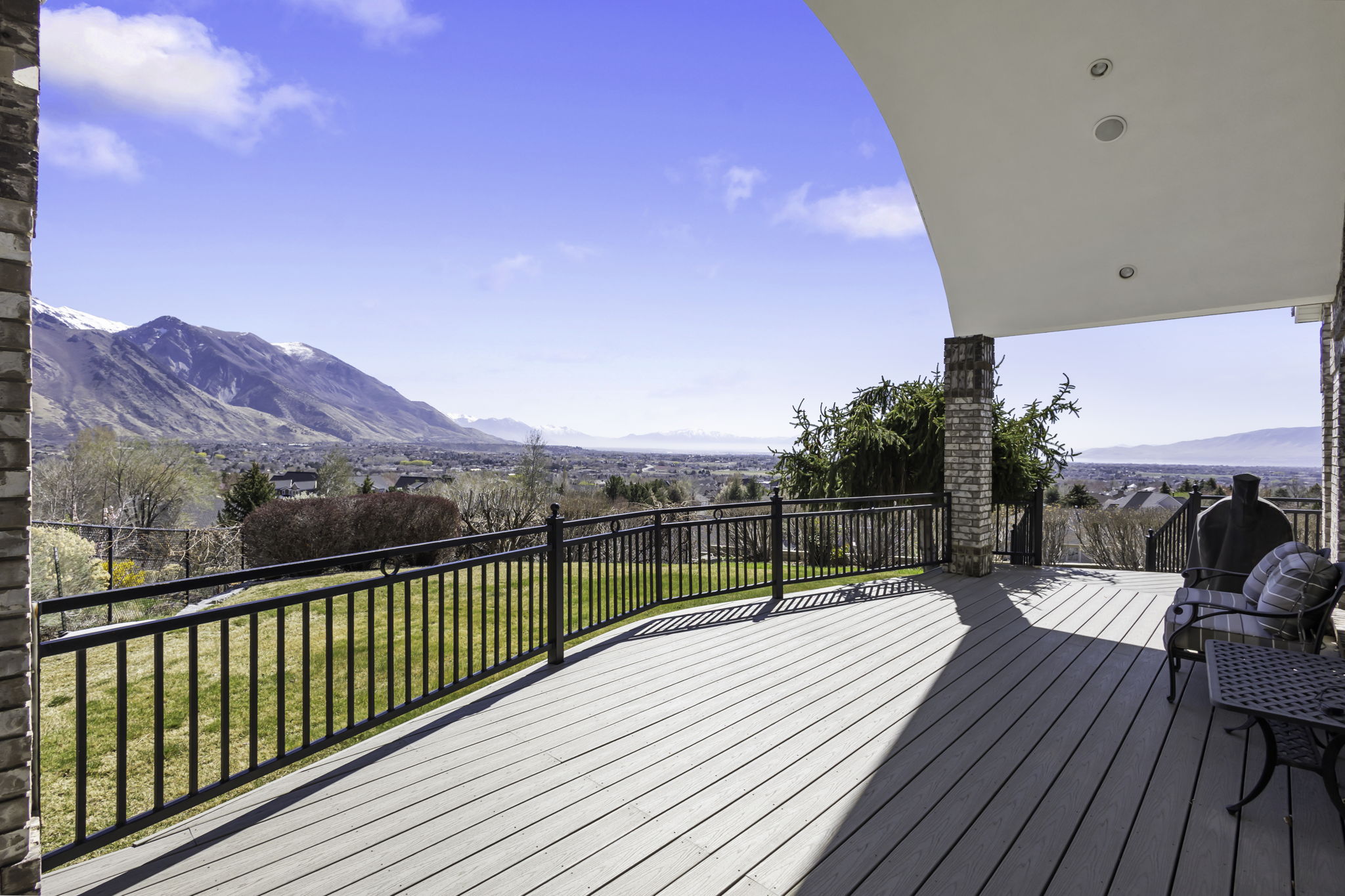 Wooden terrace featuring a yard and a mountain view