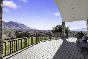 Wooden terrace featuring a yard and a mountain view