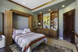Bedroom with recessed lighting, light wood-style flooring, and crown molding
