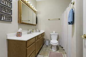 Full bath with vanity and a shower with shower curtain