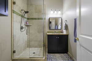 Bathroom with a stall shower and vanity