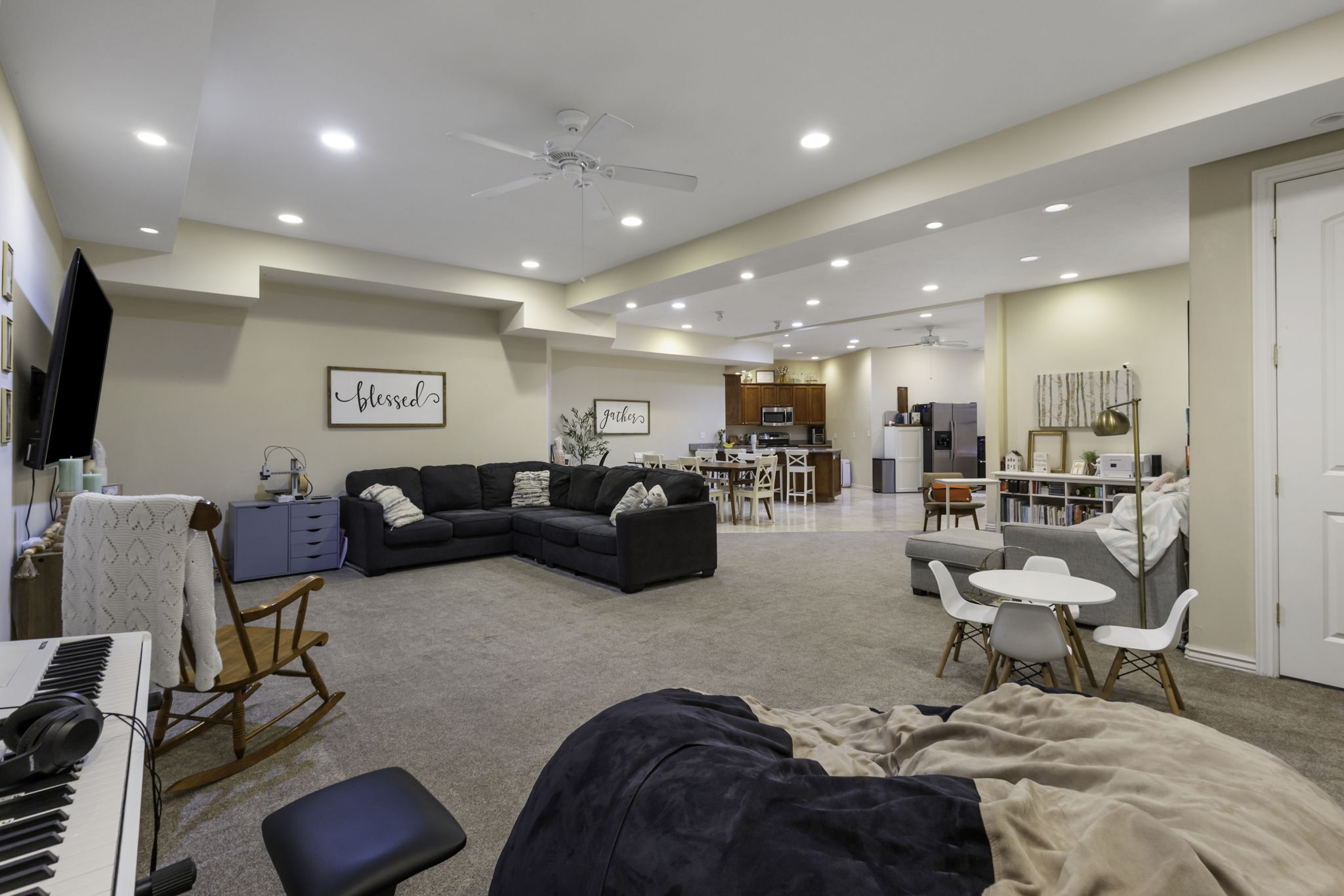 Living room with a ceiling fan, carpet flooring, and recessed lighting