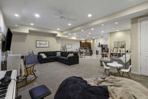Living room with a ceiling fan, carpet flooring, and recessed lighting