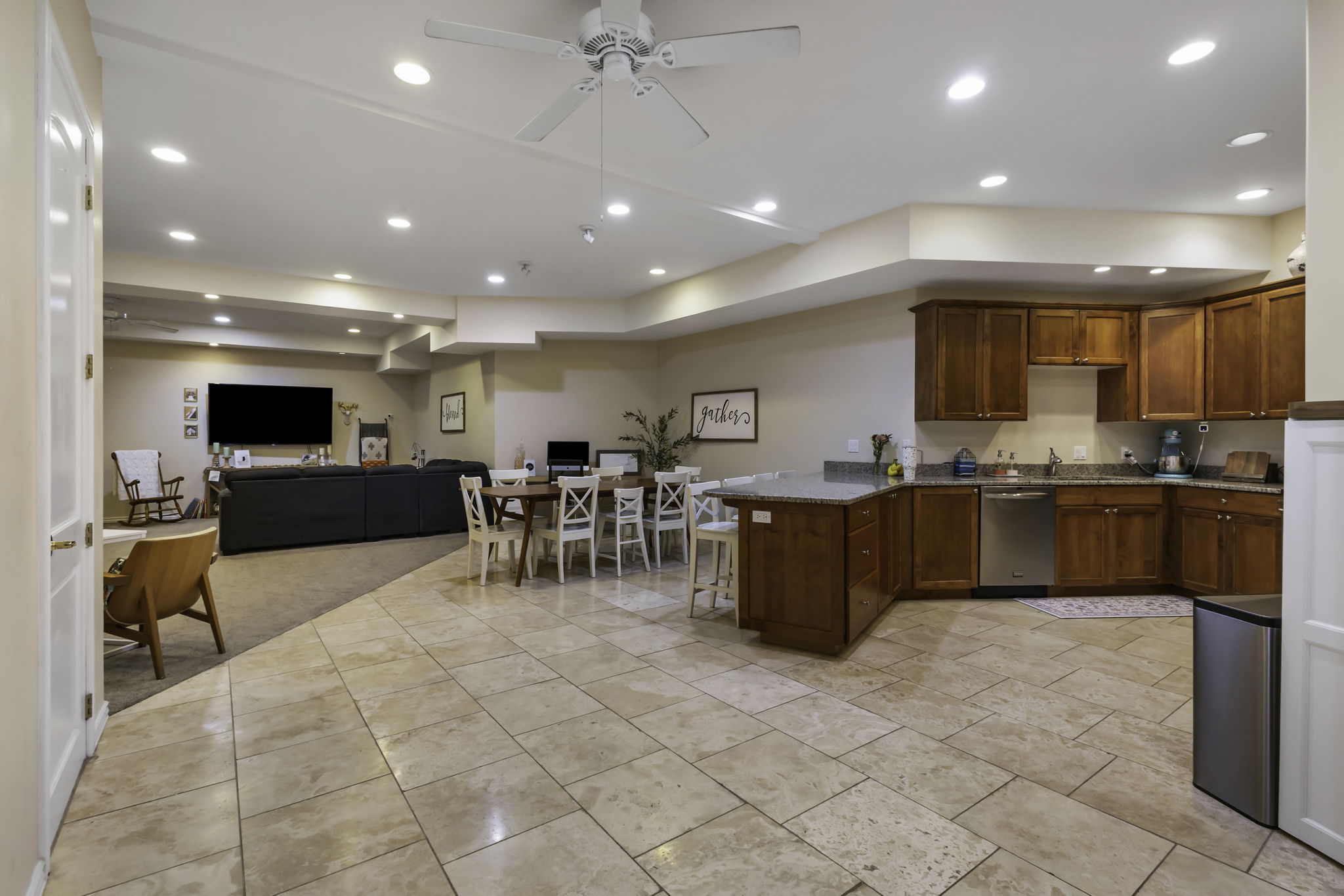 Kitchen with open floor plan, a peninsula, wood finish cabinetry, ceiling fan, and recessed lighting