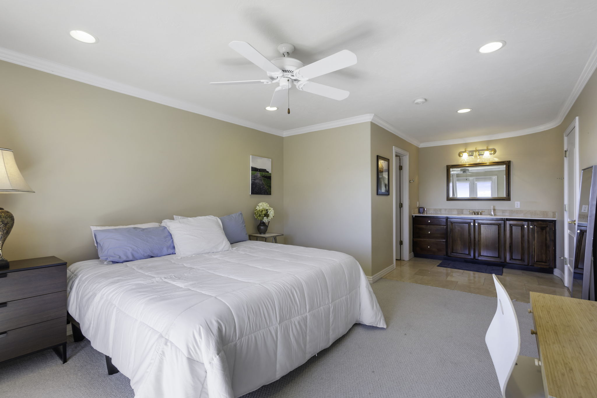 Bedroom featuring crown molding, ceiling fan, recessed lighting, light colored carpet, and stainless steel refrigerator