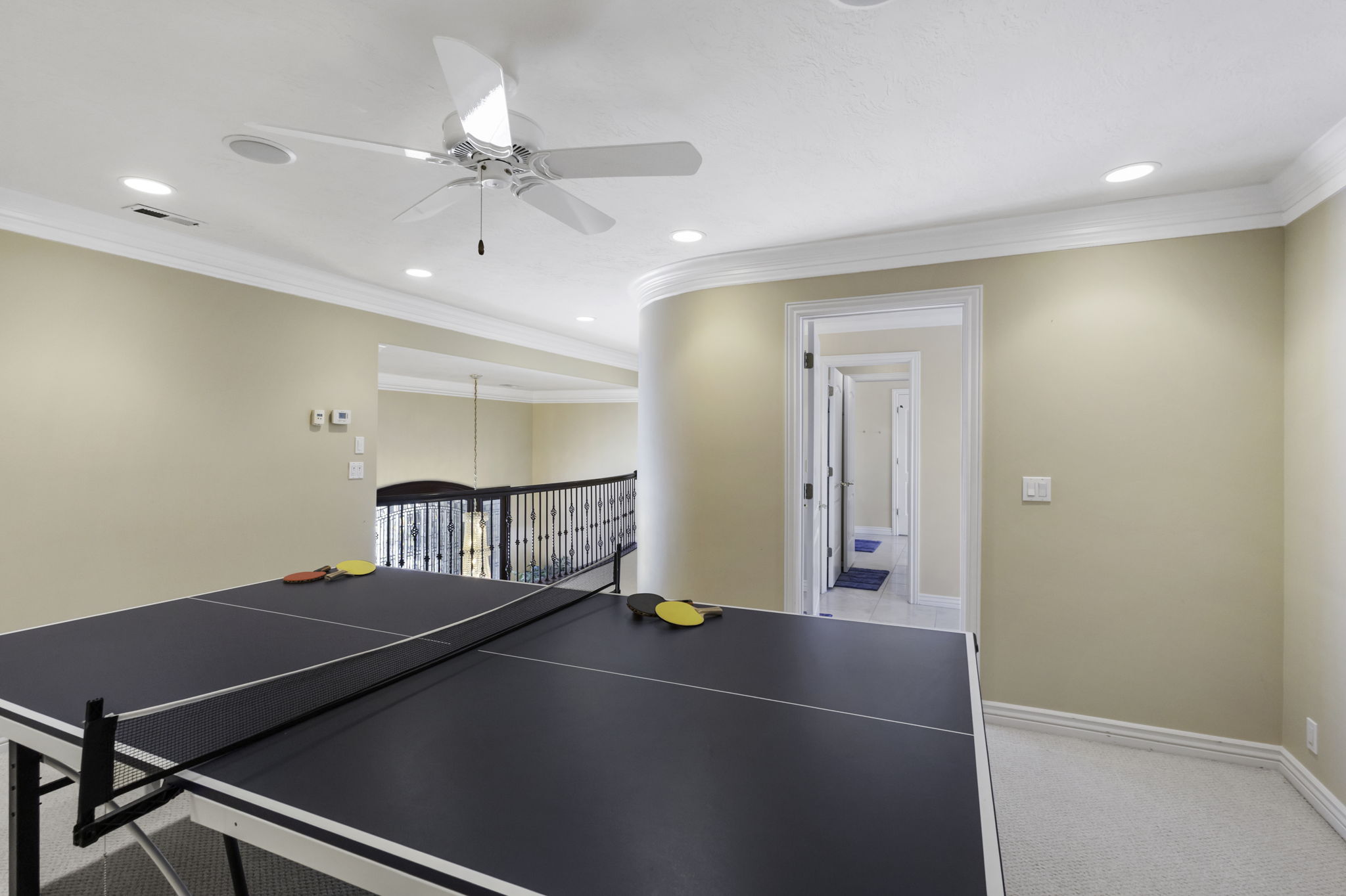 Recreation room featuring a ceiling fan, crown molding, light colored carpet, and recessed lighting