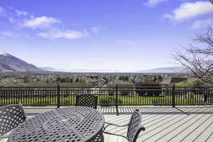 Deck featuring a residential view, a mountain view, and outdoor dining area