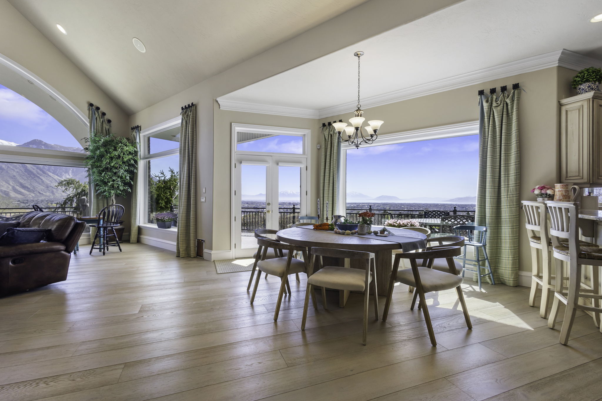 Dining area featuring healthy amount of natural light, light wood-style floors, suspended lighting, crown molding, and a mountain view