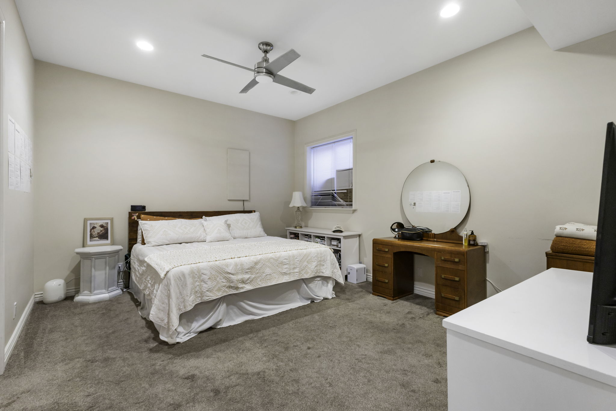 Bedroom with light carpet, a ceiling fan, and recessed lighting