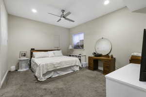 Bedroom with light carpet, a ceiling fan, and recessed lighting