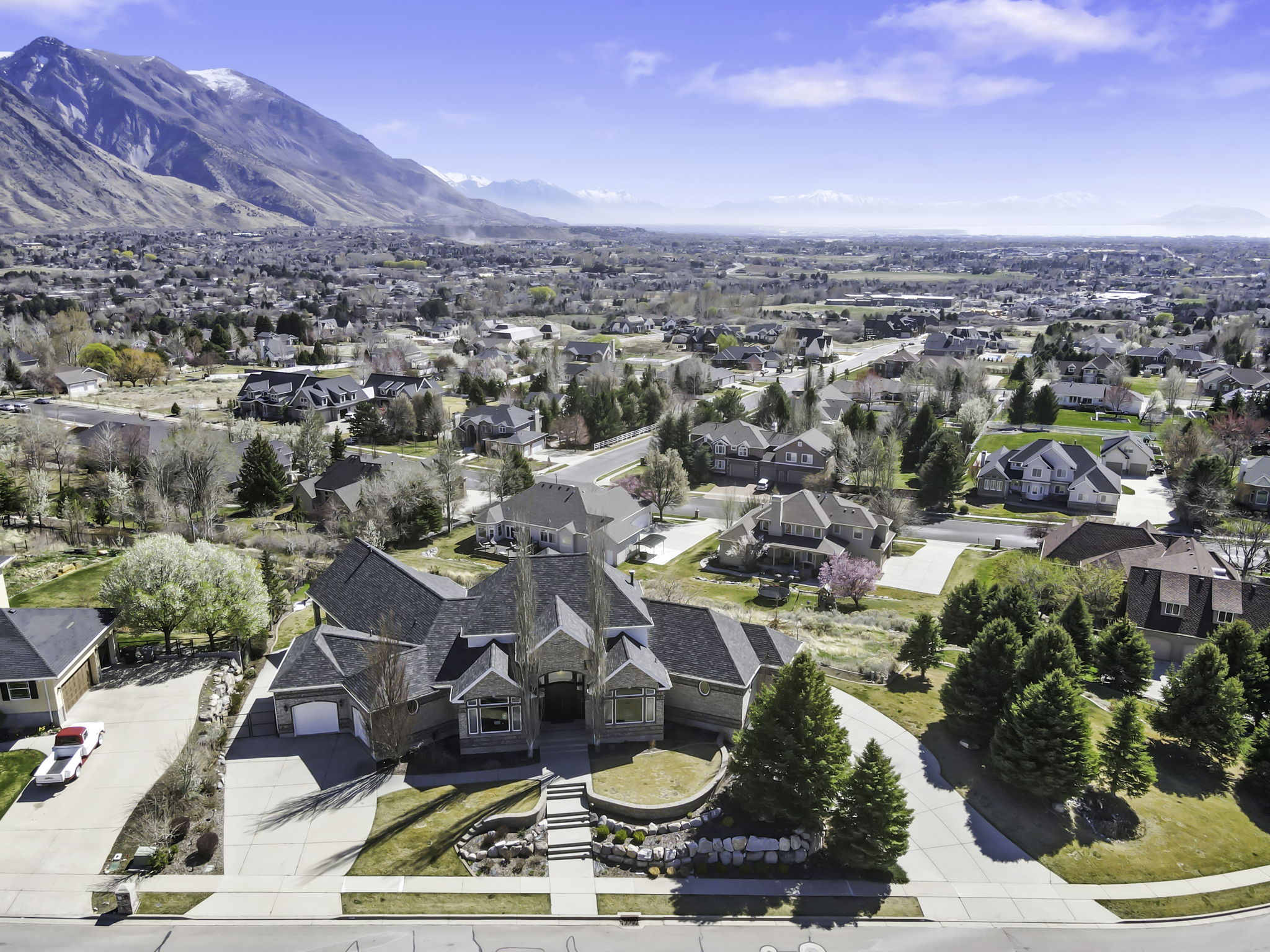 Aerial perspective of suburban area with a mountainous background
