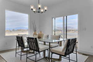 Dining space featuring a mountain view, light wood-style floors, and suspended lighting