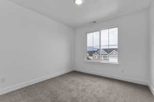 Unfurnished room with light colored carpet and baseboards
