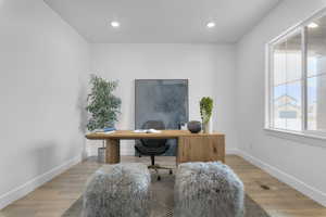 Office featuring wood finished floors and recessed lighting