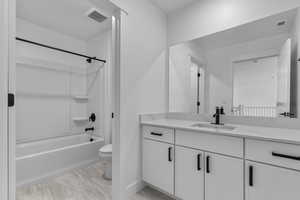 Bathroom with vanity and bathing tub / shower combination