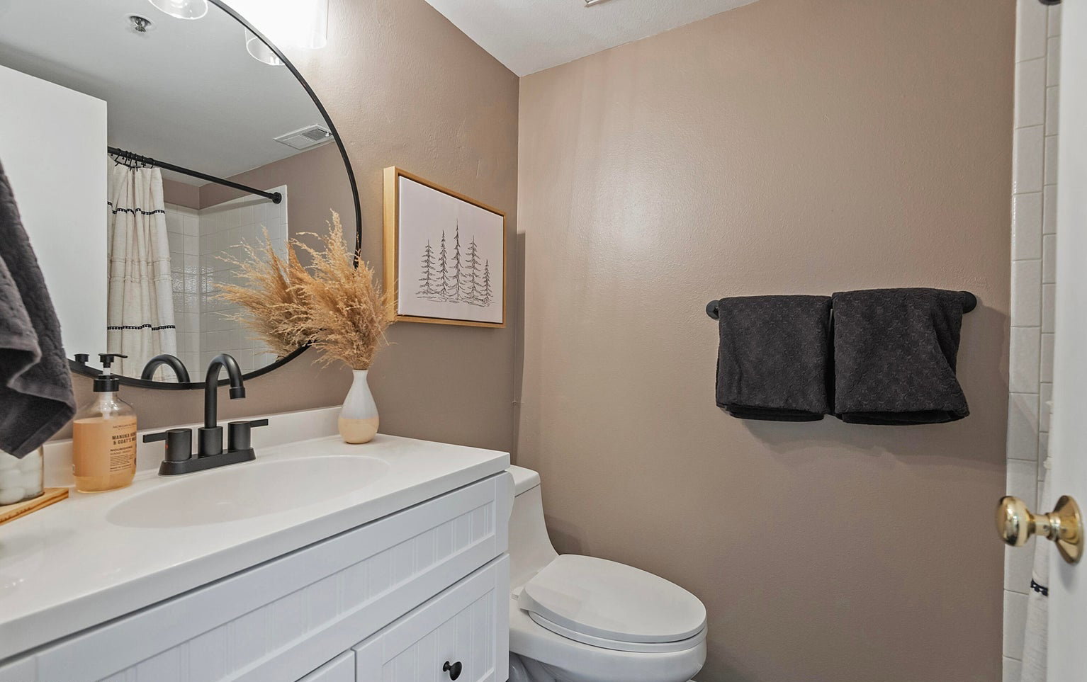 Bathroom with vanity and a shower with shower curtain