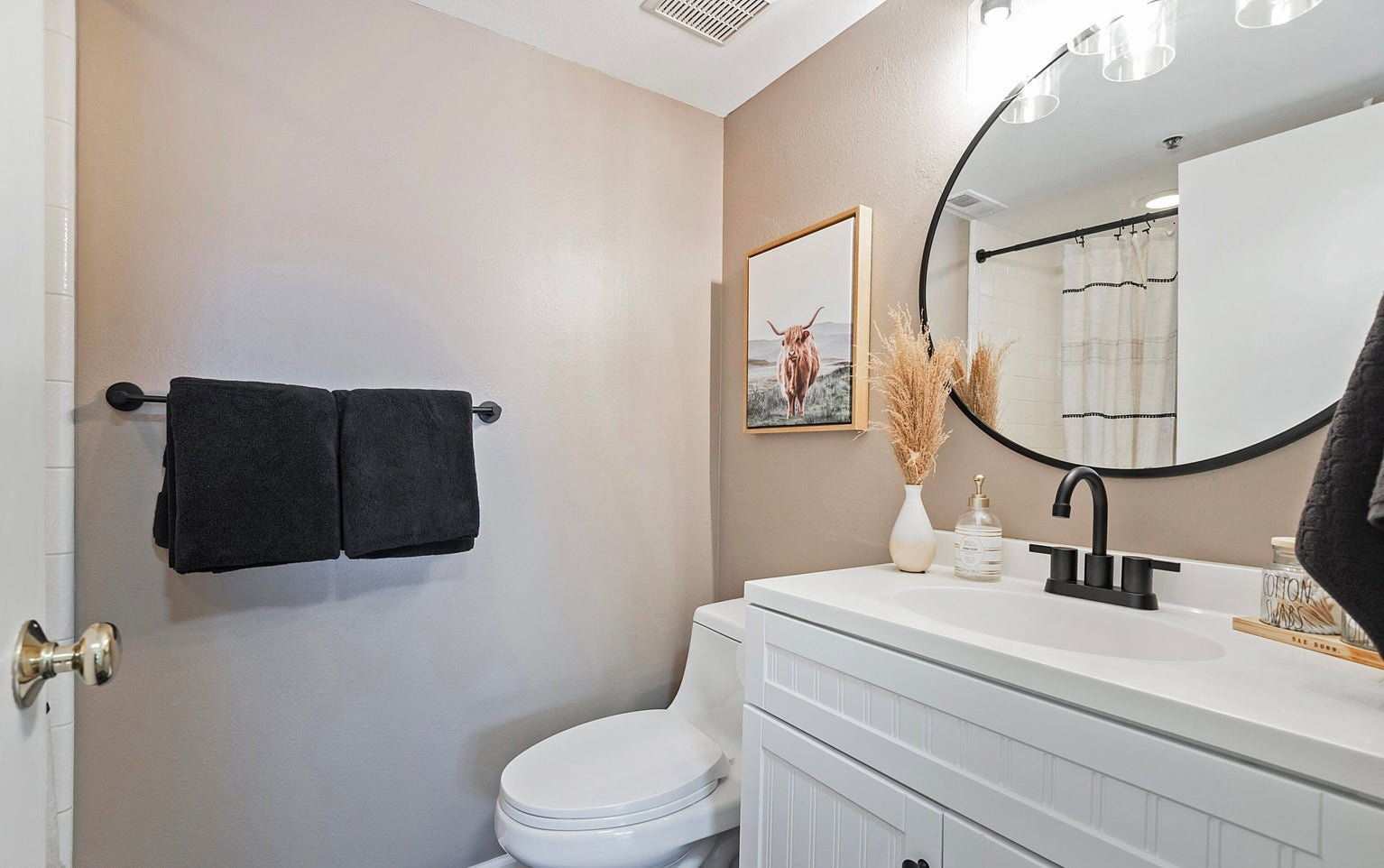 Full bathroom with vanity and curtained shower