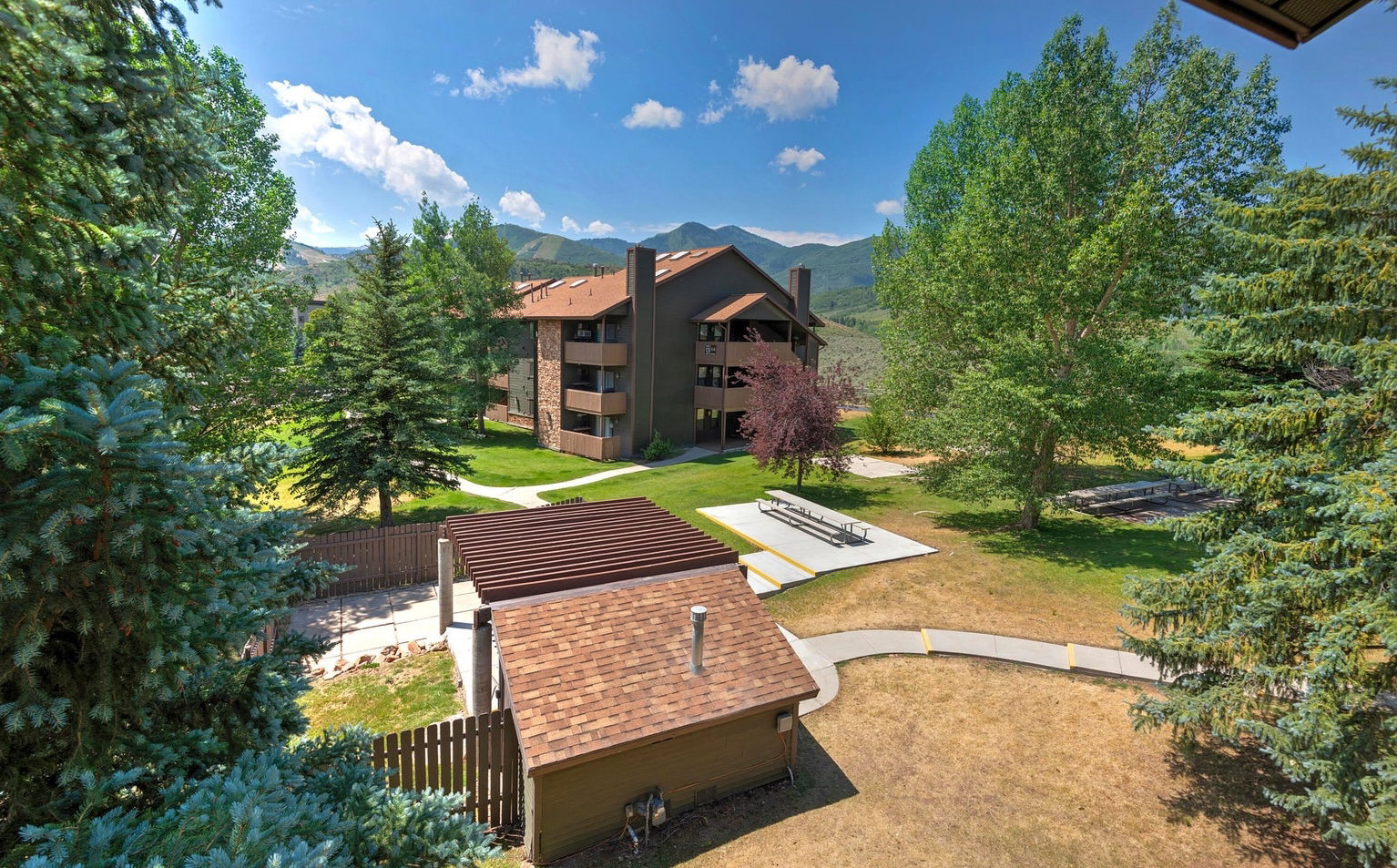 View of property's community with a mountain view and a balcony