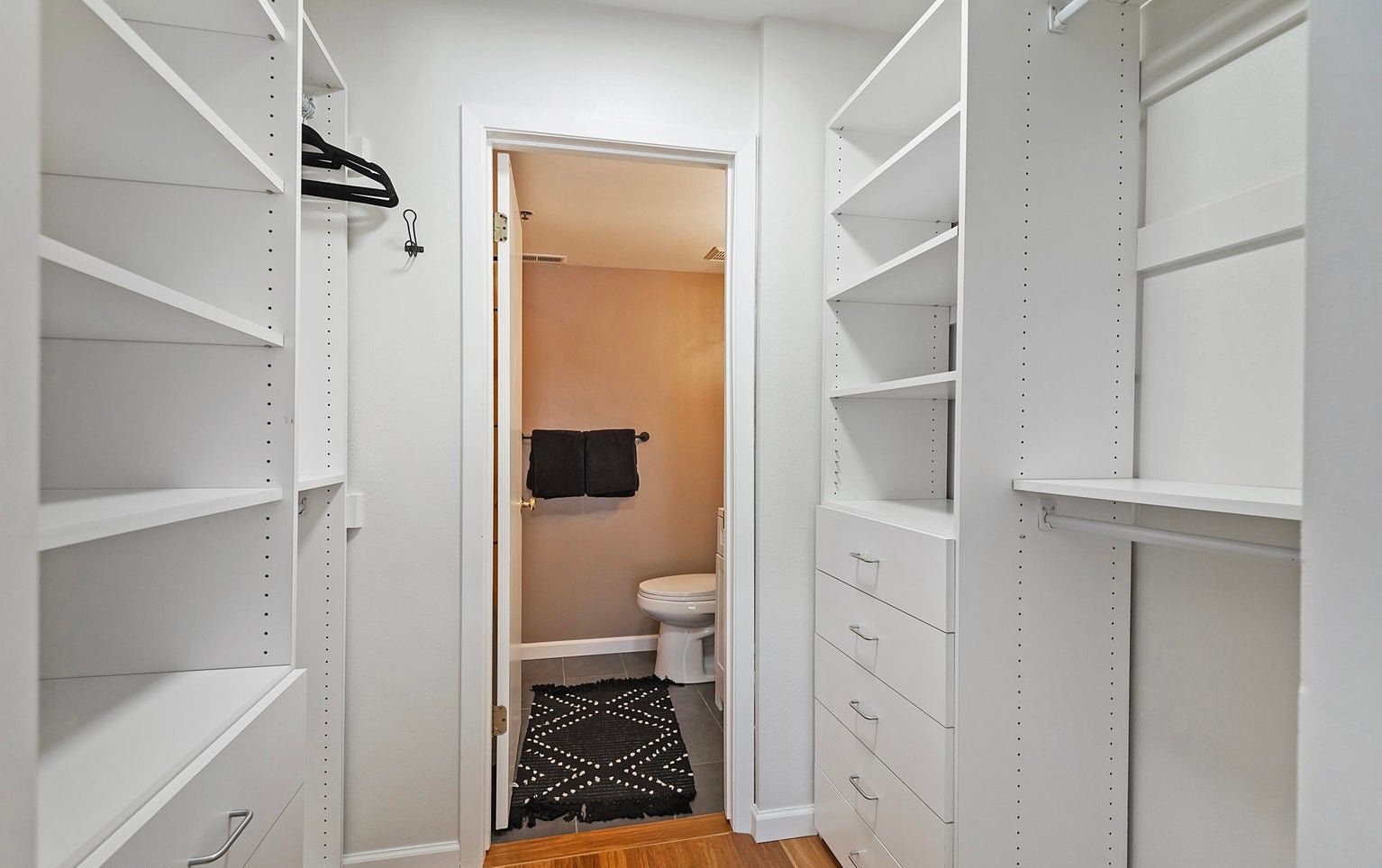 Walk in closet featuring light wood-style flooring