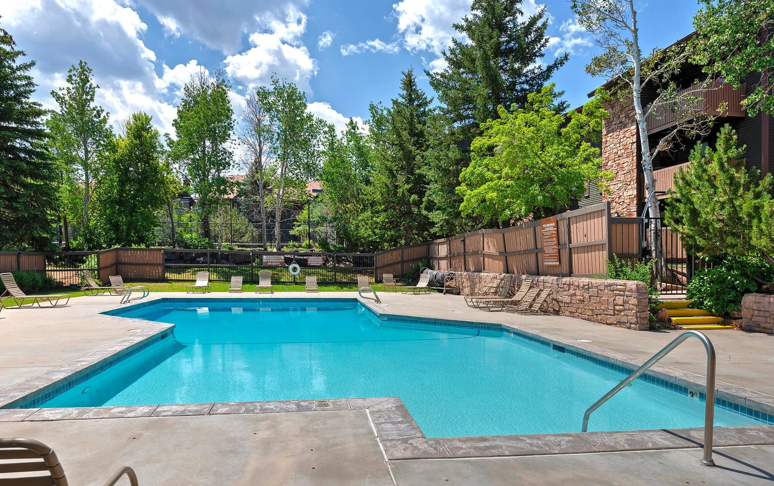 Community pool with a patio area