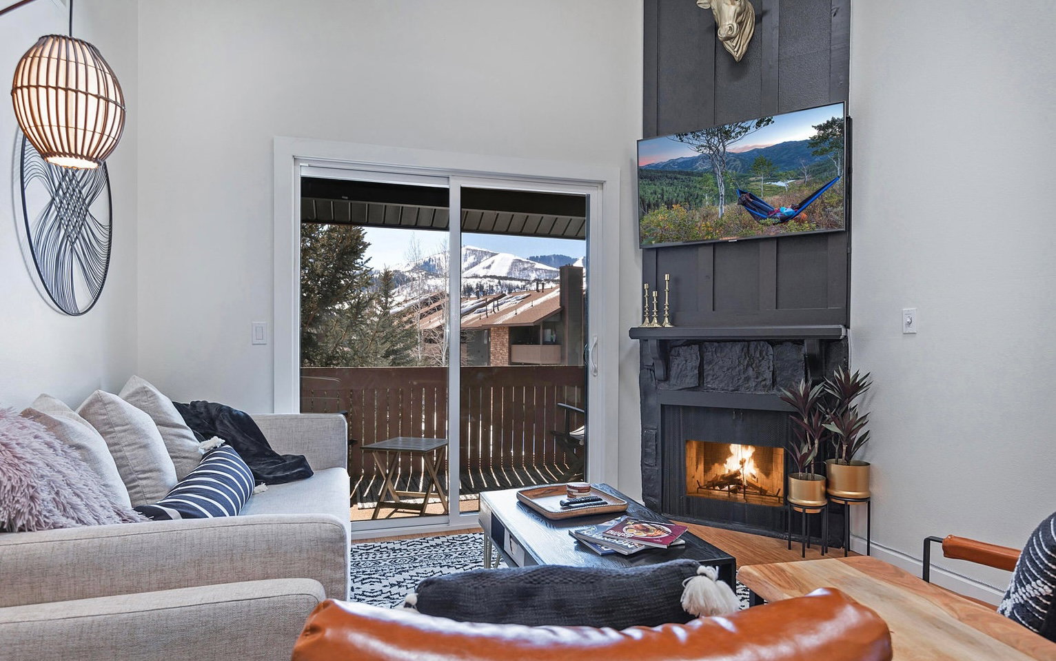 Living room featuring a lit fireplace and wood finished floors