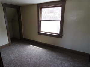 Unfurnished bedroom featuring a closet and carpet floors