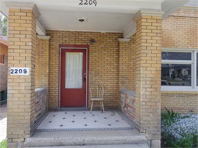 Doorway to property with brick siding